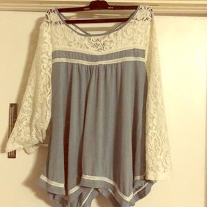 entro blue with ivory lace shark bite hem top
